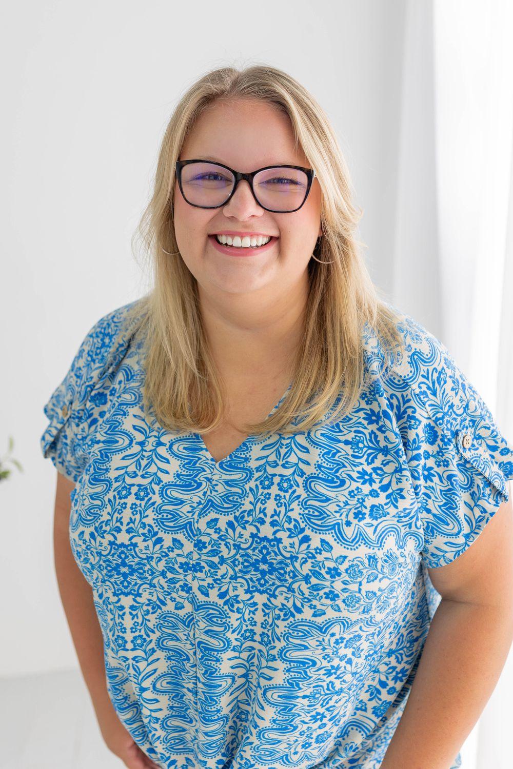 Bethany Kuhns smiling in a blue patterned top